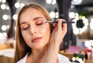 close-up-make-up-artist-applying-eyeshadow-woman-with-brush-min